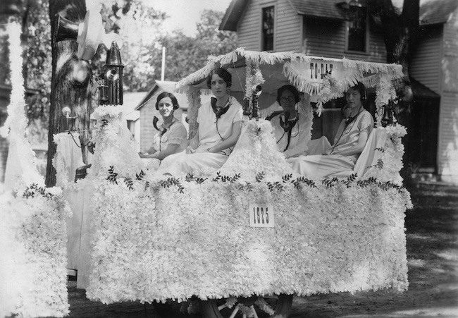 Brodhead telephone operators ride on a parade float in 1925. The photo caption simply says “Maude” which indicates Mrs. Maude Bowen is one of the ladies. BELOW: Mrs. Lulu Mattison at left, looking over four telephone operators in this undated photo from Truman Olin.